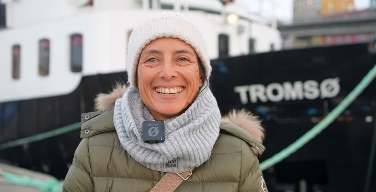 The bow of MS Tromsø with a happy guest at the quay